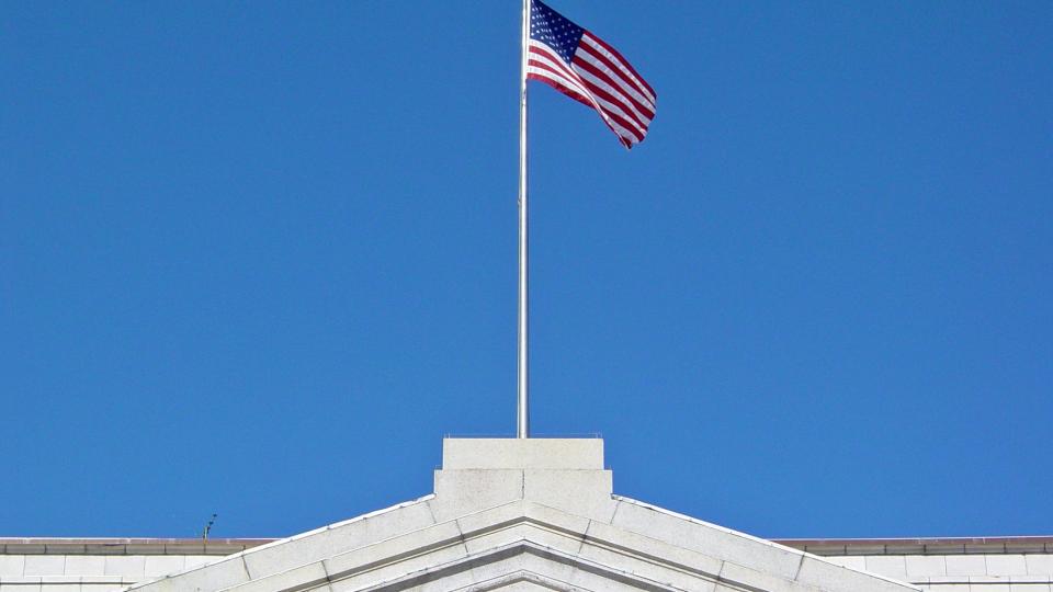 Flag atop the United States Department of the Treasury building, on Pennsylvania Avenue NW in Washington, DC. Photo by Ben Schumin via Flickr, CC-BY-2.0