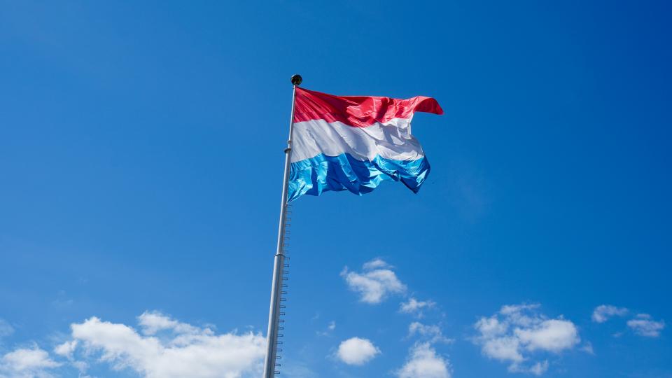 Luxembourg flag against blue sky