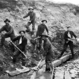 Miners at work with picks and shovels during the 19th century gold rush in Klondike, Alaska. 
